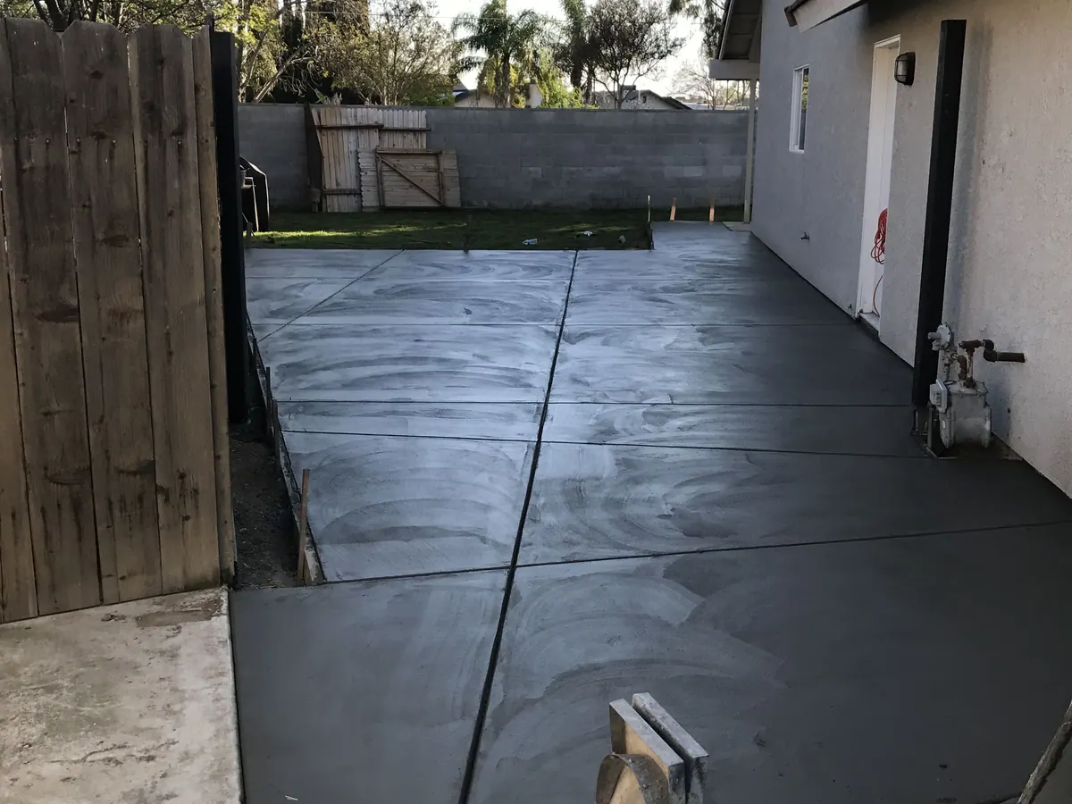 Freshly poured concrete driveway and side approach