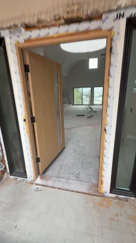 New entry doorway framed and protected part way through a commercial build-out