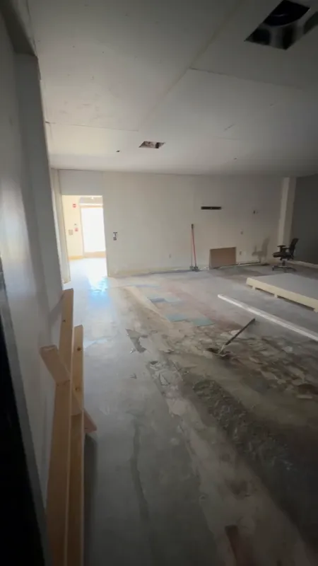 Commercial interior part way through build-out with new partitions framed and the slab swept ahead of finishes