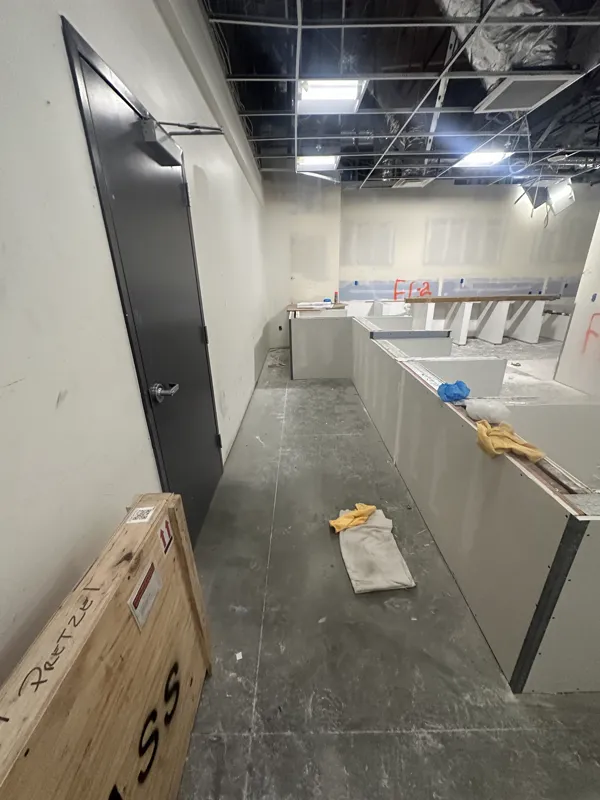 Commercial counter under construction with equipment still crated on the floor beside it