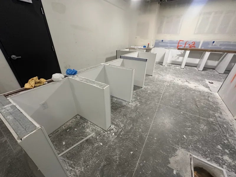 Drywall partitions taped and marked up with fire-protection references ahead of finishing