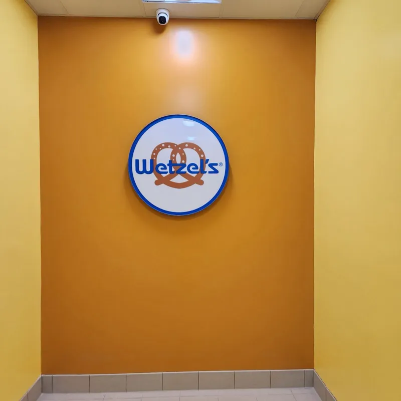 Finished feature wall in the completed unit with the tenant logo mounted and lit